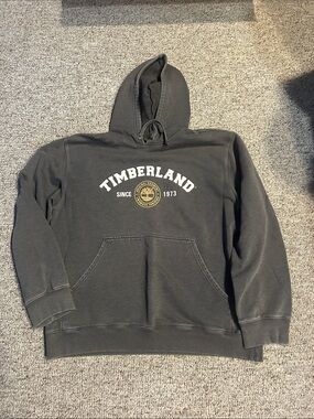 Timberland Dark Charcoal Hoodie with White Logo and Gold Emblem